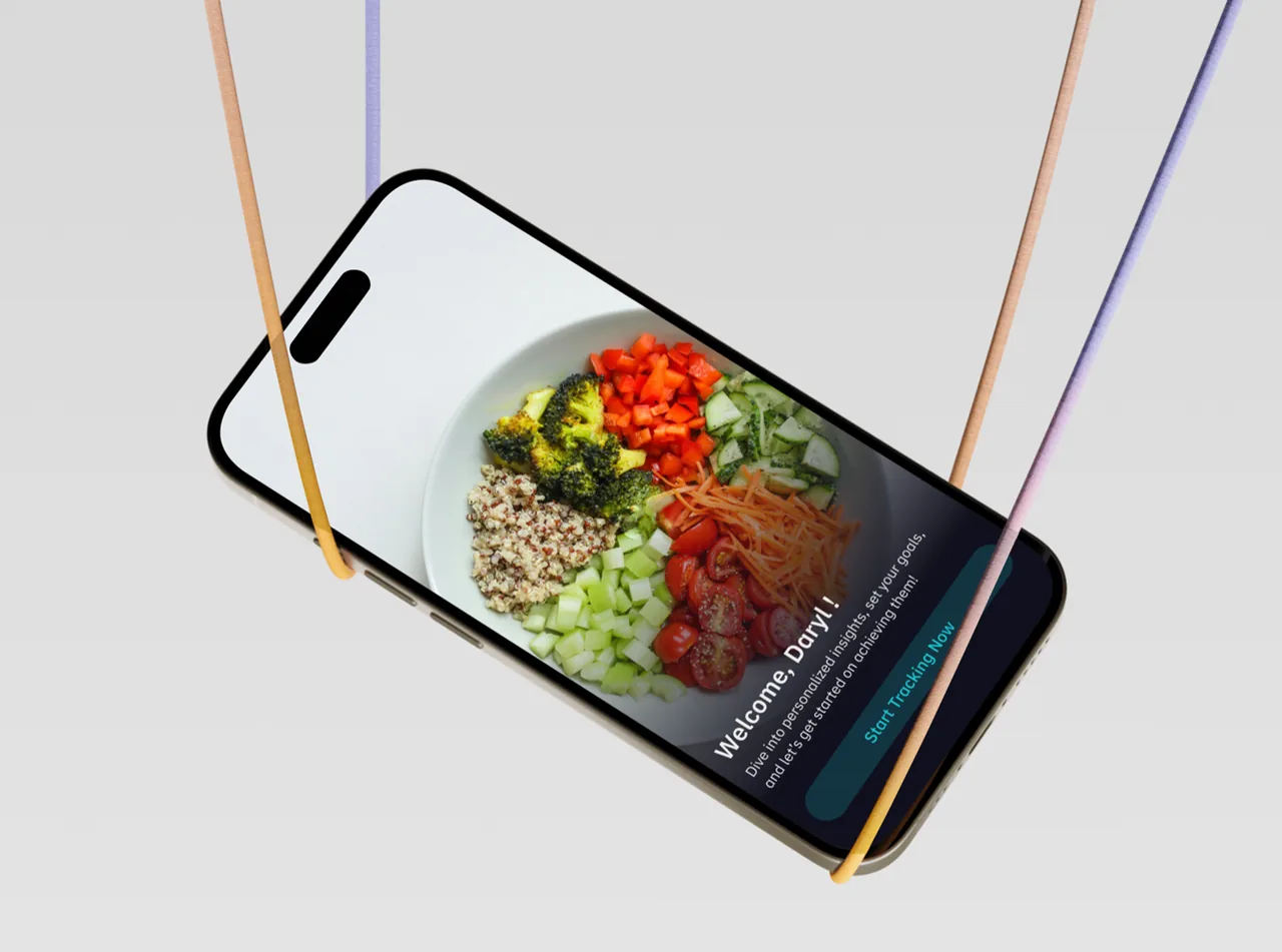 The nutrition app welcome screen on a phone balanced above a pepper and a lemon on a plate